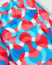 Introducing the Psycho Bunny MENS WALTER LIGHTWEIGHT PRINT SWIM TRUNK - B6W863D200: these shorts showcase a vibrant wavy pattern in red, white, and shades of blue. Crafted from 100% polyester, they feature an elastic waistband and a front flap pocket secured with a velcro closure.