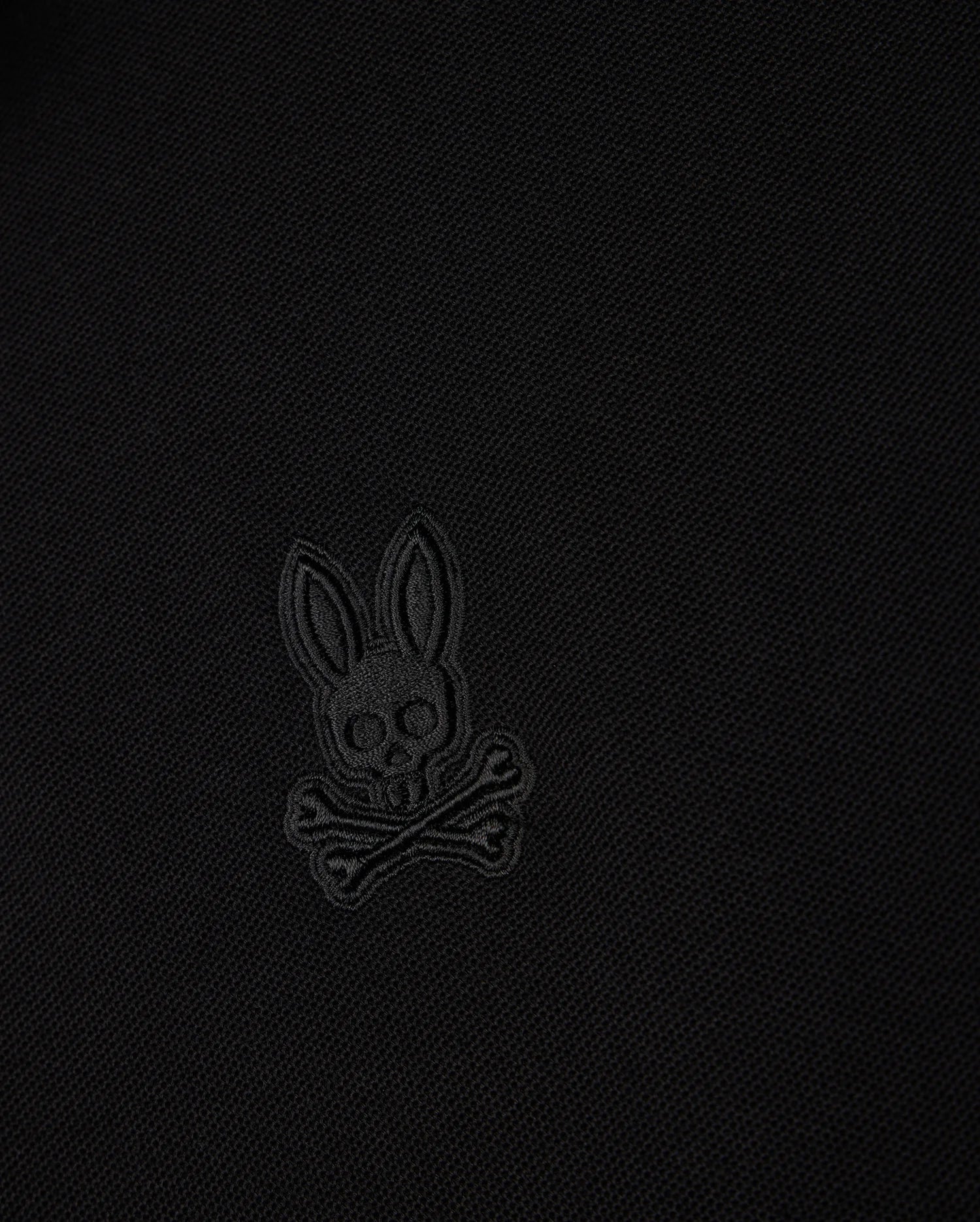 Made from soft Pima cotton, the BIG AND TALL MALTON PIQUE POLO SHIRT by Psycho Bunny features a skull and crossbones with rabbit ears in black stitching for a minimalist vibe, reflecting the timeless style of their Malton polo.