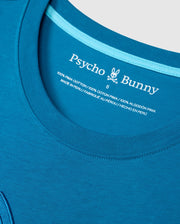 Close-up of a Psycho Bunny tee collar. The inside label features the brand logo, size 6, and fabric details: Big and Tall Malton Graphic Tee - B9U795D200 is crafted from 100% Pima cotton, highlighting exceptional Peruvian craftsmanship in English, Spanish, and French.