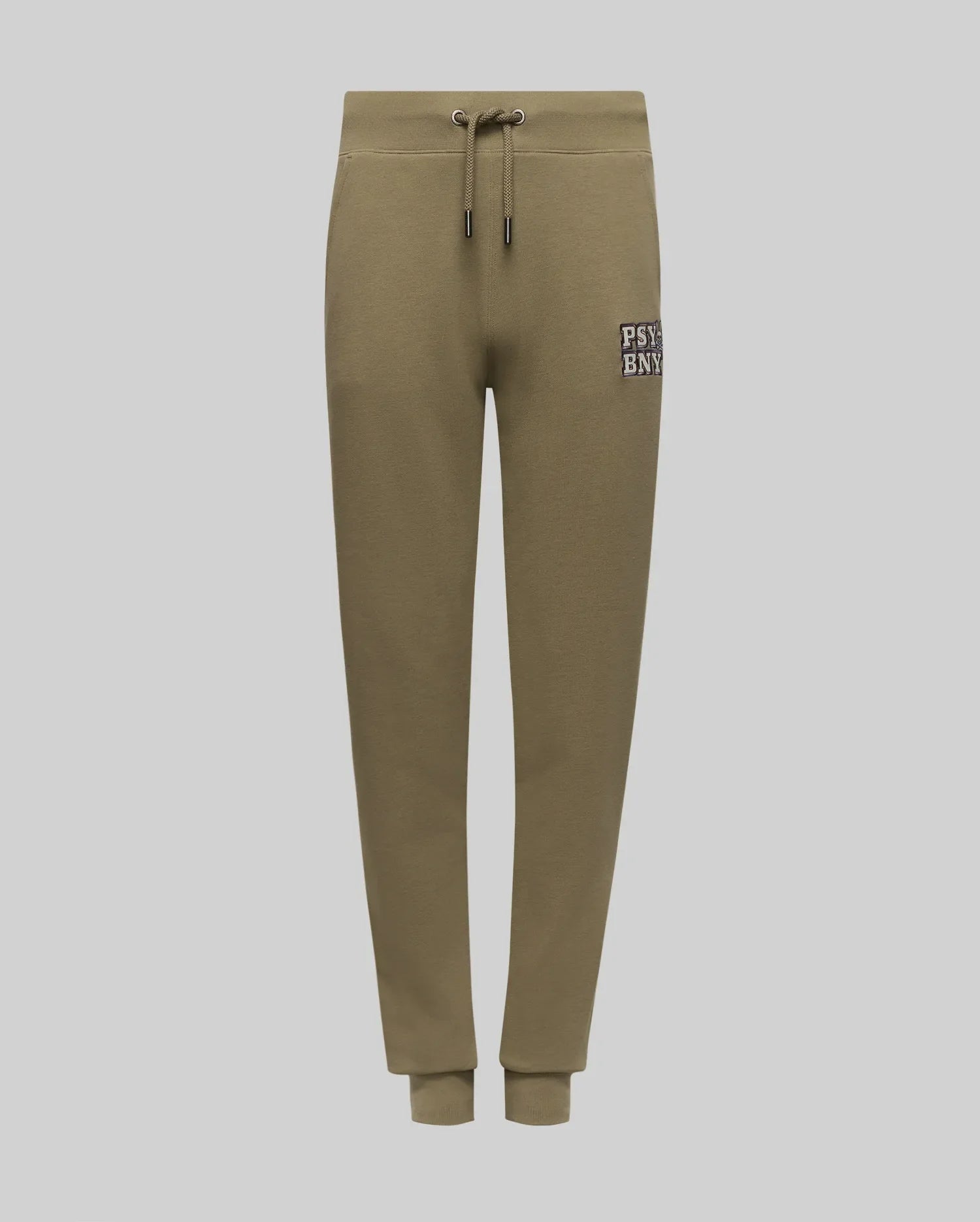 The KIDS WADE SWEATPANT - KB0800002 by Psycho Bunny is an olive green jogger with elastic waistband, drawstring, side pockets, ribbed cuffs, and a small "PSNY" patch on the left thigh. Shown on a plain light gray background.