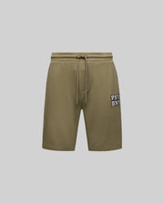 The MENS WADE SWEATSHORT - MB0900028 by Psycho Bunny features olive green, classic athletic style with side pockets, an embroidered "PSYBNY" patch on the left leg, and a premium cotton blend. Shown against a plain light gray background.
