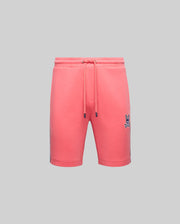 The Psycho Bunny MENS DAWSON TRACK SHORT - MB0900032 features a coral pink hue with a small embroidered bunny logo on the left thigh, blending loungewear comfort and relaxed street style, shown against a plain gray background.