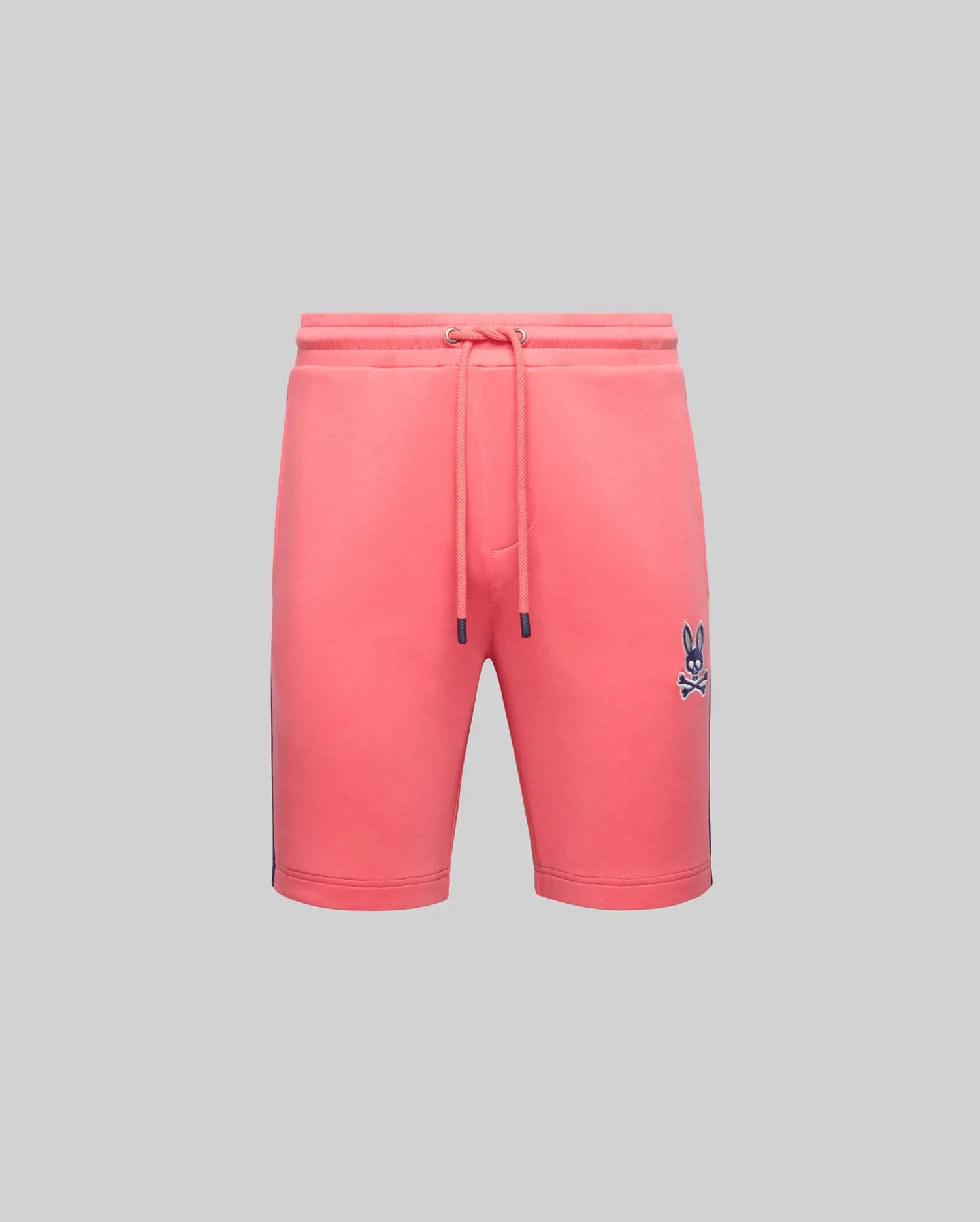 The Psycho Bunny MENS DAWSON TRACK SHORT - MB0900032 features a coral pink hue with a small embroidered bunny logo on the left thigh, blending loungewear comfort and relaxed street style, shown against a plain gray background.