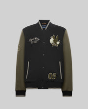 The Psycho Bunny MENS AUGUSTE KNIT BOMBER (MO1100050) is a black and olive varsity jacket with front snap buttons, embroidered text, chenille bunny and flower patches, number "05" on one side, and "53" on the sleeve; shown on a gray background.