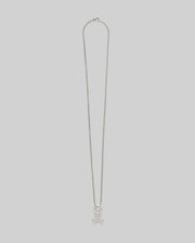 The MENS BUNNY NECKLACE - MO1700022 by Psycho Bunny features a steel pendant with a skull and crossbones design, set against a plain light gray background.