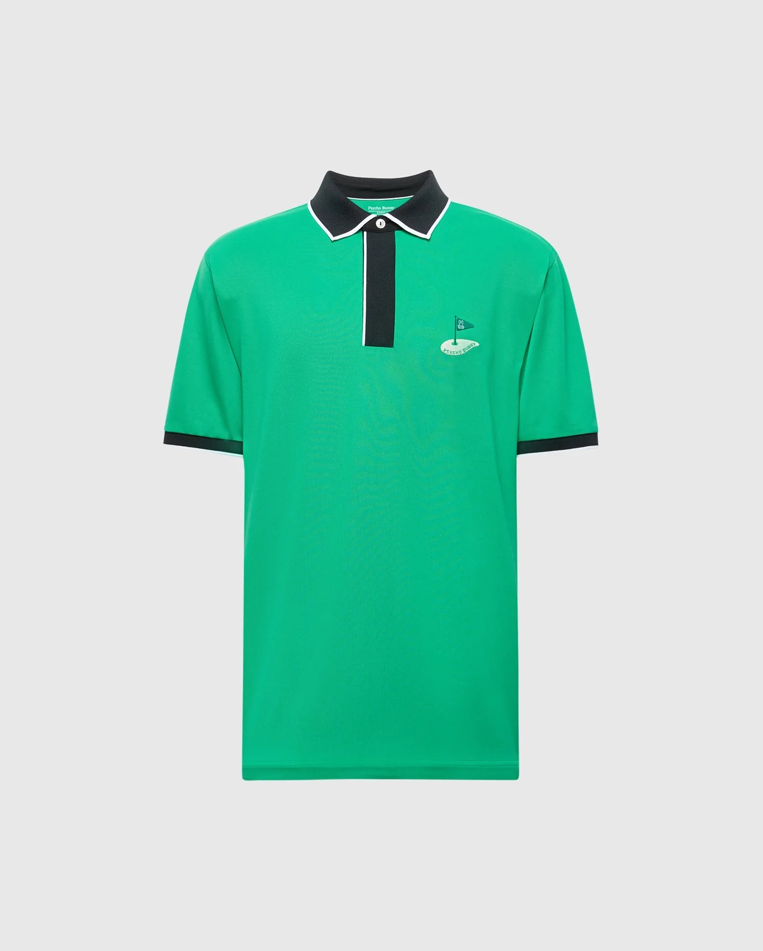 The Psycho Bunny MENS CLAYTON PIQUE POLO (MT0100004) is a green polo shirt made from Pima cotton, featuring colorblocking with a black collar, white-trimmed placket, and short sleeves for breathability. A small flag logo is embroidered on the left chest against a plain white background.