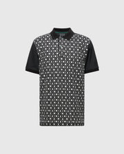 The Psycho Bunny MENS BECKETT PIQUE POLO (MT0100022) is a short-sleeved, breathable polo with a black and white geometric pattern on the front. Made from Pima cotton, it features solid black collar and sleeves and a small green tag inside the collar for added detail.