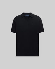 Mens Devon Knit Polo in black, featuring a subtle textured knit, classic fit, V-neck placket, and a tonal embroidered Psycho Bunny skull logo on the left chest.