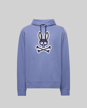 The Psycho Bunny Men's Ryder Bunny Hoodie (MT0500029) is a light purple hoodie with a bold black bunny face and white crossed bones graphic, an embroidered Bunny patch, front pocket, and drawstrings for cozy loungewear style.