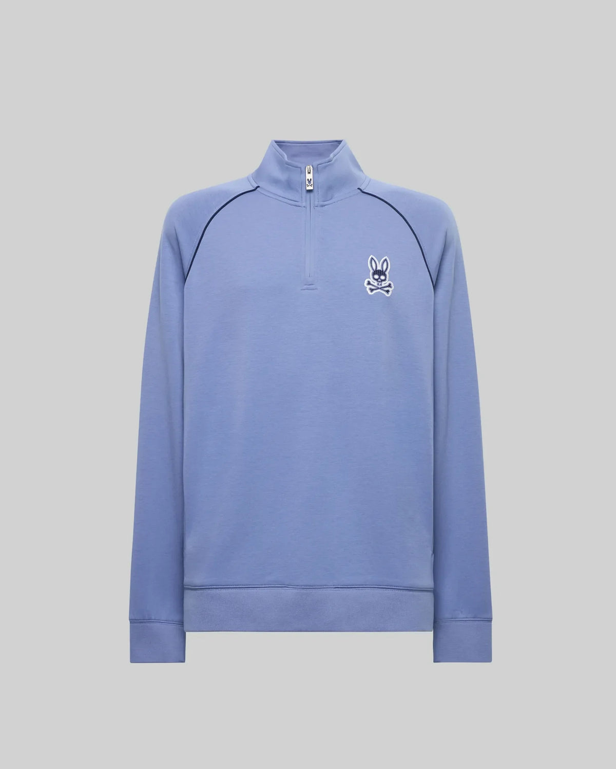 The Psycho Bunny MENS SHAWN QUARTER ZIP SWEATSHIRT (MT0500115) features a light blue design with a 1/4 zip, long sleeves, high collar, and white bunny logo. Made from premium cotton-modal knit for comfort and minimal style.