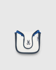 A small, white and blue crossbody bag with black trim, made from durable polyurethane. It showcases a Psycho Bunny logo with crossbones on the front and a side branded tag. Manufactured in China, it's displayed against a plain light background.