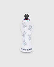 The MULTI BUNNY HYBRID HEAD COVER - PBMG4SH3 by Psycho Bunny features a white ripstop fabric with a blue logo, bunny skull motifs, a black top handle, and red-white-blue striped trim on a light gray background, offering PGA-ready style.