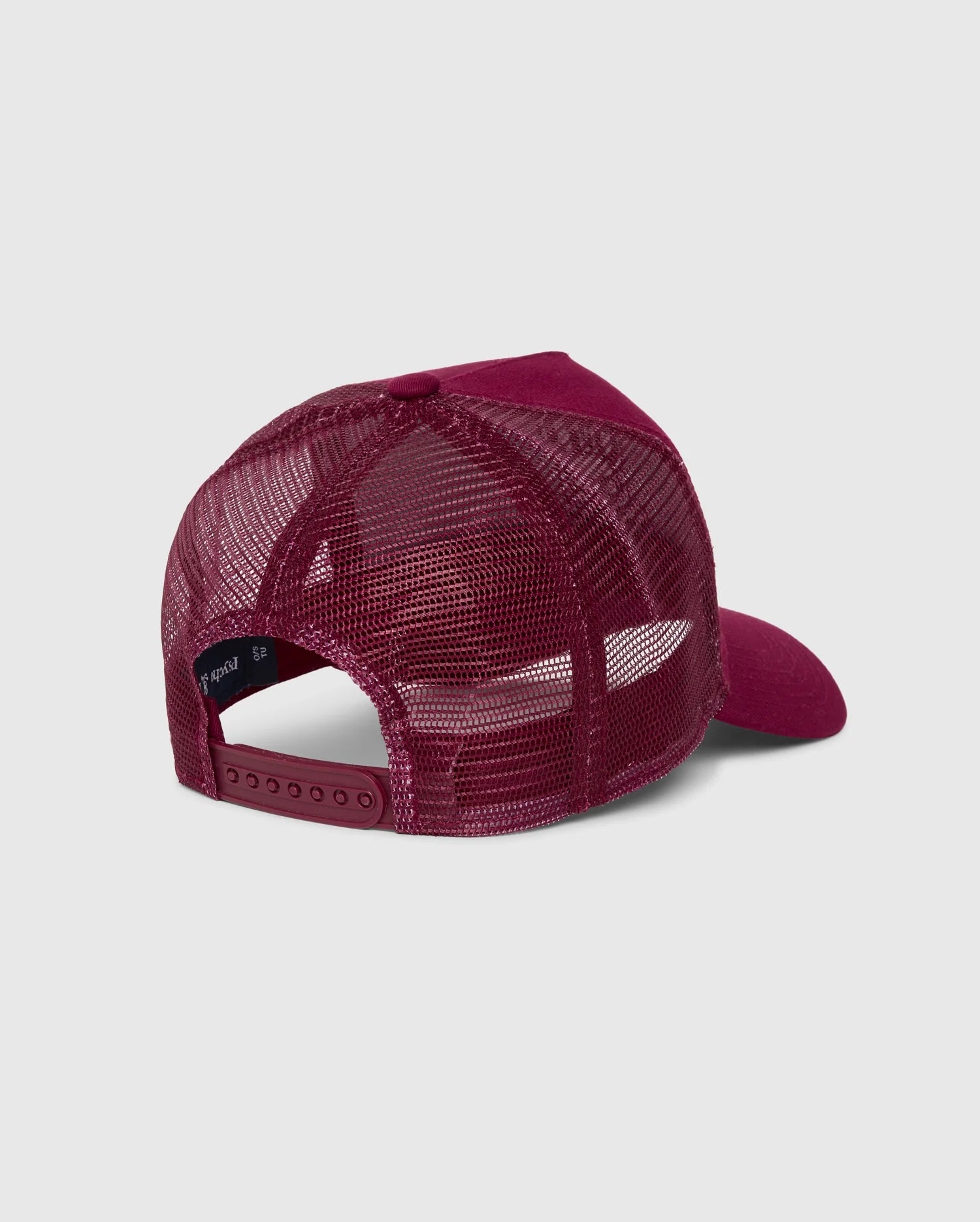 The back view of the maroon Psycho Bunny KIDS MALTON TRUCKER CAP - B0A797D200 showcases a breathable mesh design and adjustable snap closure, ideal for active kids. Its front panels feature solid fabric, providing a nice contrast to the mesh back.