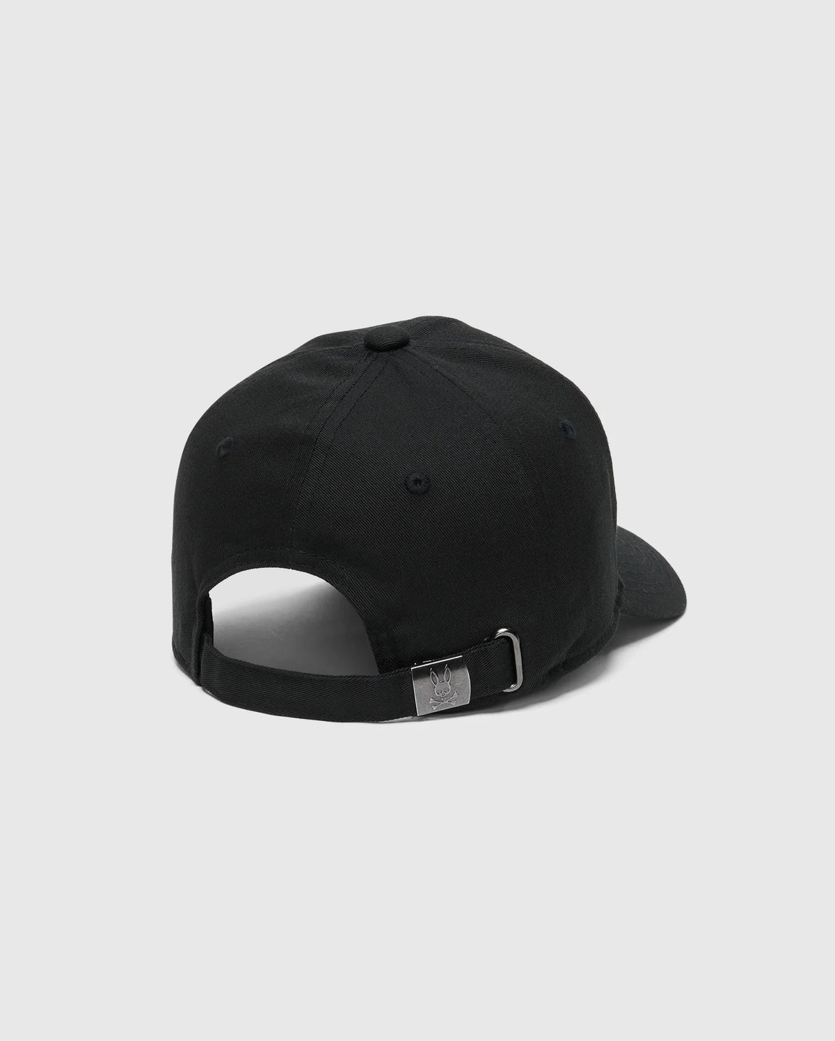 The KIDS CLASSIC BASEBALL CAP - B0A816A1HT by Psycho Bunny features an adjustable fit with a black strap at the back. It includes a metal buckle engraved with the logo and has an embroidered bunny on the front, set against a plain white background.