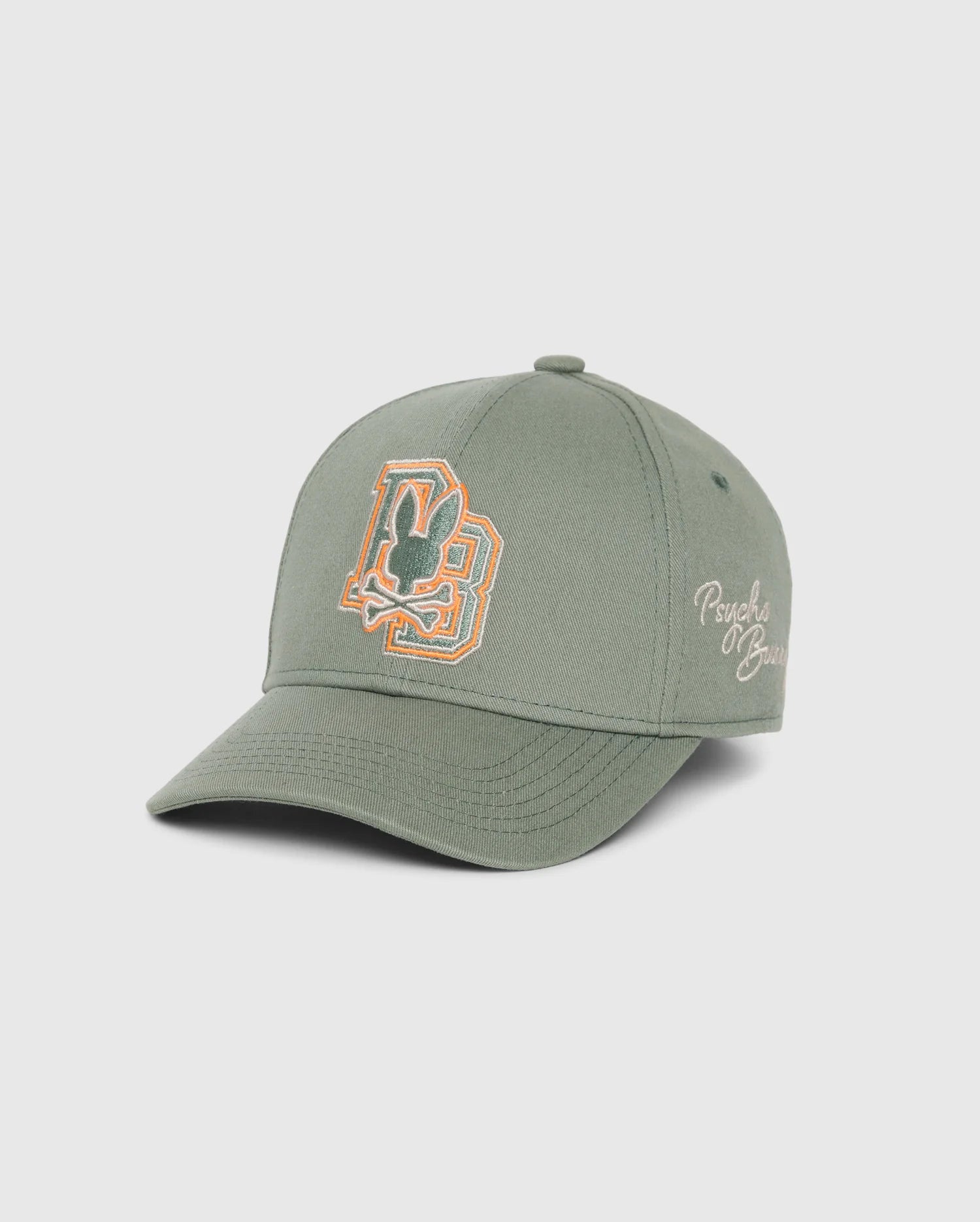 Introducing the KIDS ZACK BASEBALL CAP - B0A886D200 by Psycho Bunny: This sporty green cap is expertly crafted from woven cotton and features an embroidered "P" and "B" design on the front. "Psychic Blues" is elegantly stitched on the side, creating a perfect blend of style and comfort. The cap is presented against a plain white background for a clean look.