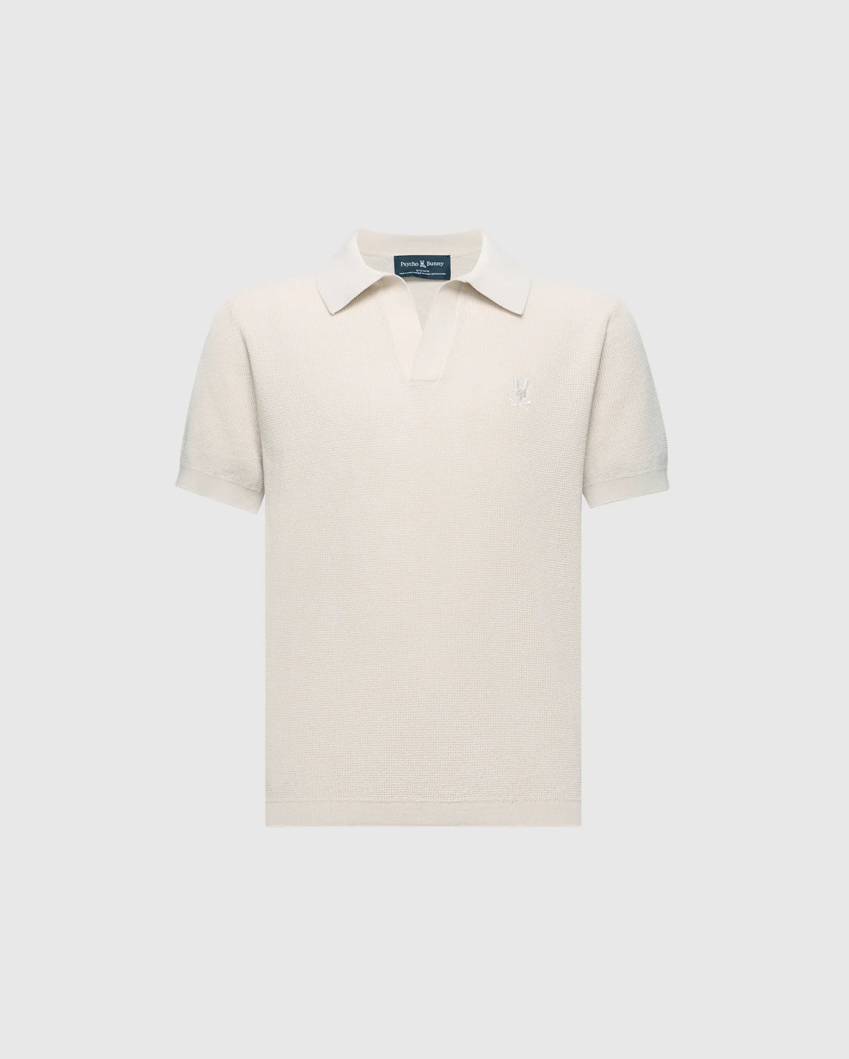The Psycho Bunny KIDS LEETON JOHNNY COLLAR KNIT POLO (B0E562F200) is a white short-sleeve polo in 100% cotton with a buttonless collar, set against light gray. A small embroidered bunny logo on the left chest makes it ideal for transitional wear.