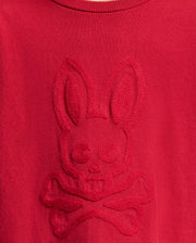 The KIDS COORY CHAINSTITCH COTTON SWEATER from Psycho Bunny is crafted in red extra fine cotton and features a unique embossed bunny skull with crossbones design.