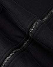 Close-up of a black 100% cotton fabric with two parallel zippers. The fabric, likely from the Psycho Bunny KIDS LEVY ZIP FLEECE HOODIE - B0H720D200, appears thick and durable. The metallic zippers interlock snugly, their shine contrasting subtly with the rich texture of the material.