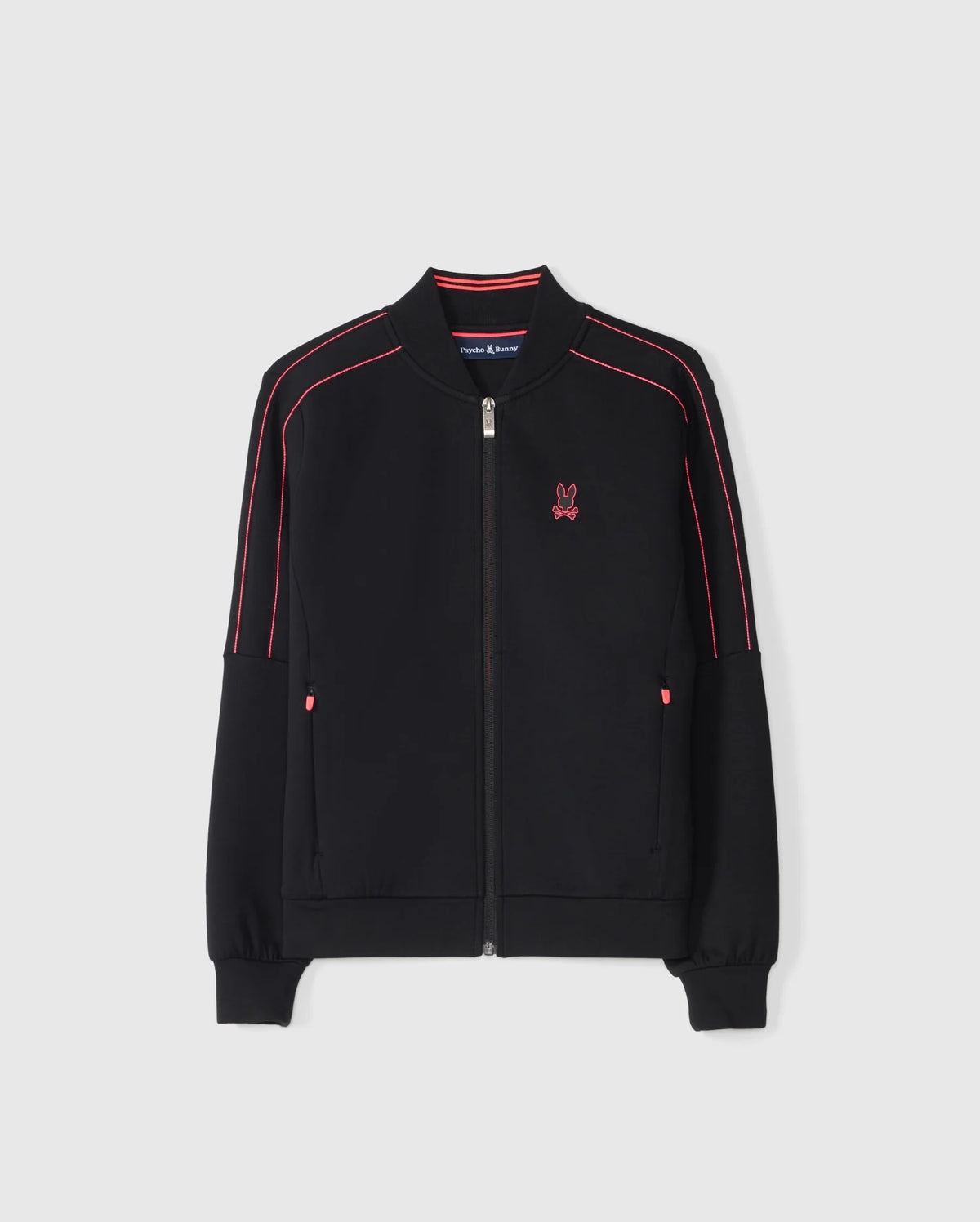 The KIDS TRAVIS TRACK JACKET - B0J142D200 by Psycho Bunny is a black regular-fit jacket featuring striking red piping along the sleeves and shoulders. This high-quality cotton-blend piece includes a distinct red embroidered rabbit logo on the left chest, two convenient pockets, and ribbed cuffs and hem, all displayed against a plain white background.