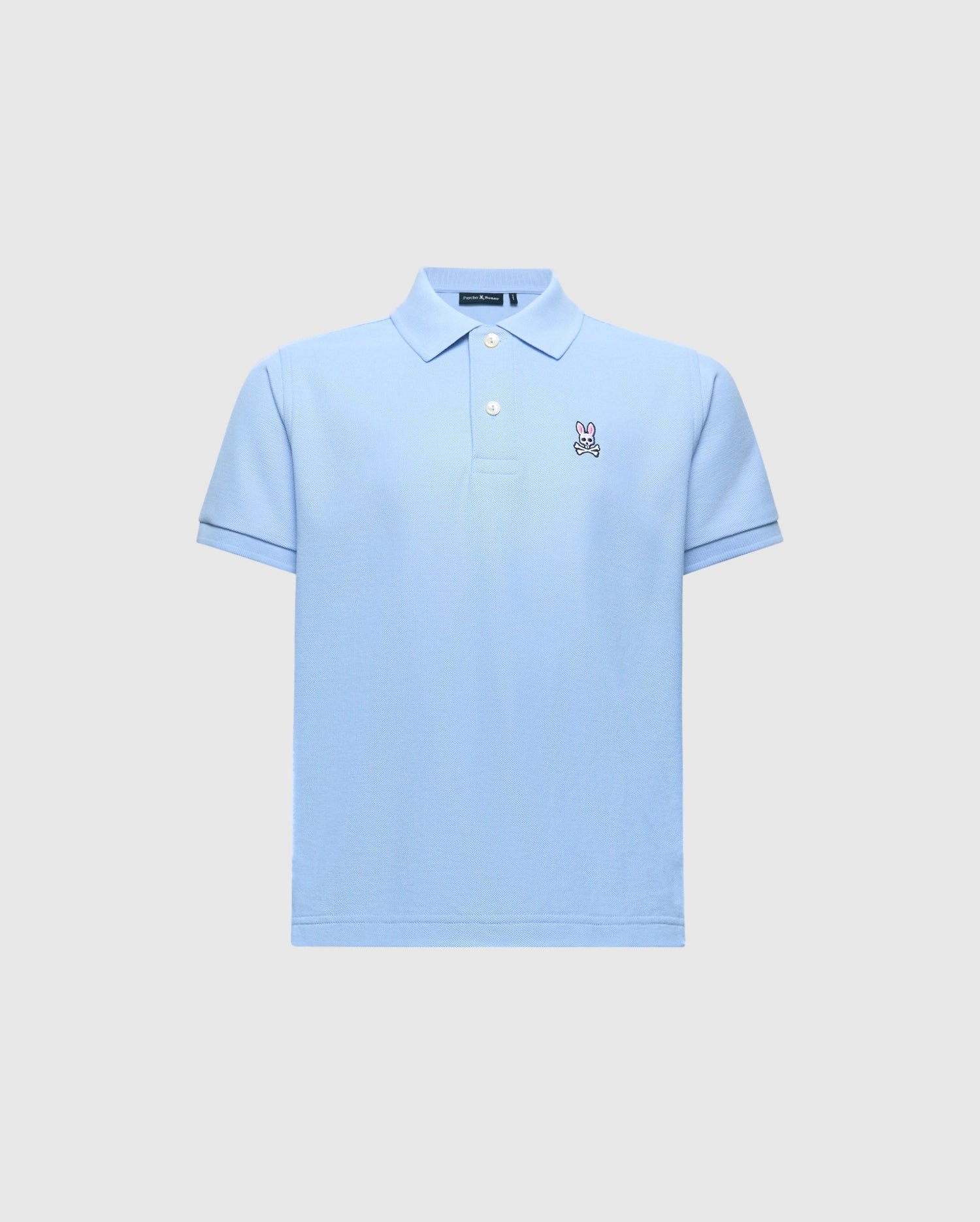 The Kids Classic Pique Polo (B0K001B200) by Psycho Bunny is crafted from soft Pima cotton in light blue, featuring a collar, short sleeves, and an embroidered Bunny logo on the left chest against a plain light gray background.