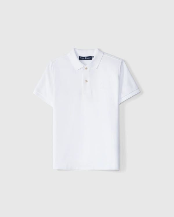 A Psycho Bunny Kids Classic Pique Polo Shirt (B0K021AR00) features a plain white design on a light gray background, crafted from luxurious Pima cotton. It has short sleeves, a classic collar, three white buttons, and an embroidered Bunny logo.
