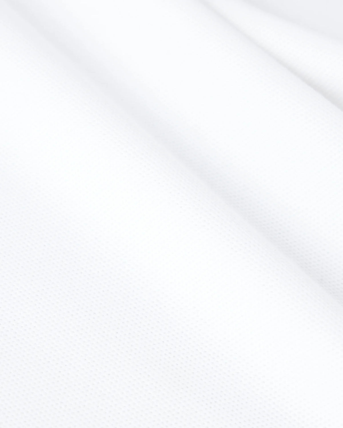 Psycho Bunny's KIDS CLASSIC PIQUE POLO SHIRT - B0K021AR00 is made from white textured Pima cotton with a slightly wavy surface, revealing a fine weave and smooth appearance ideal for a classic polo.