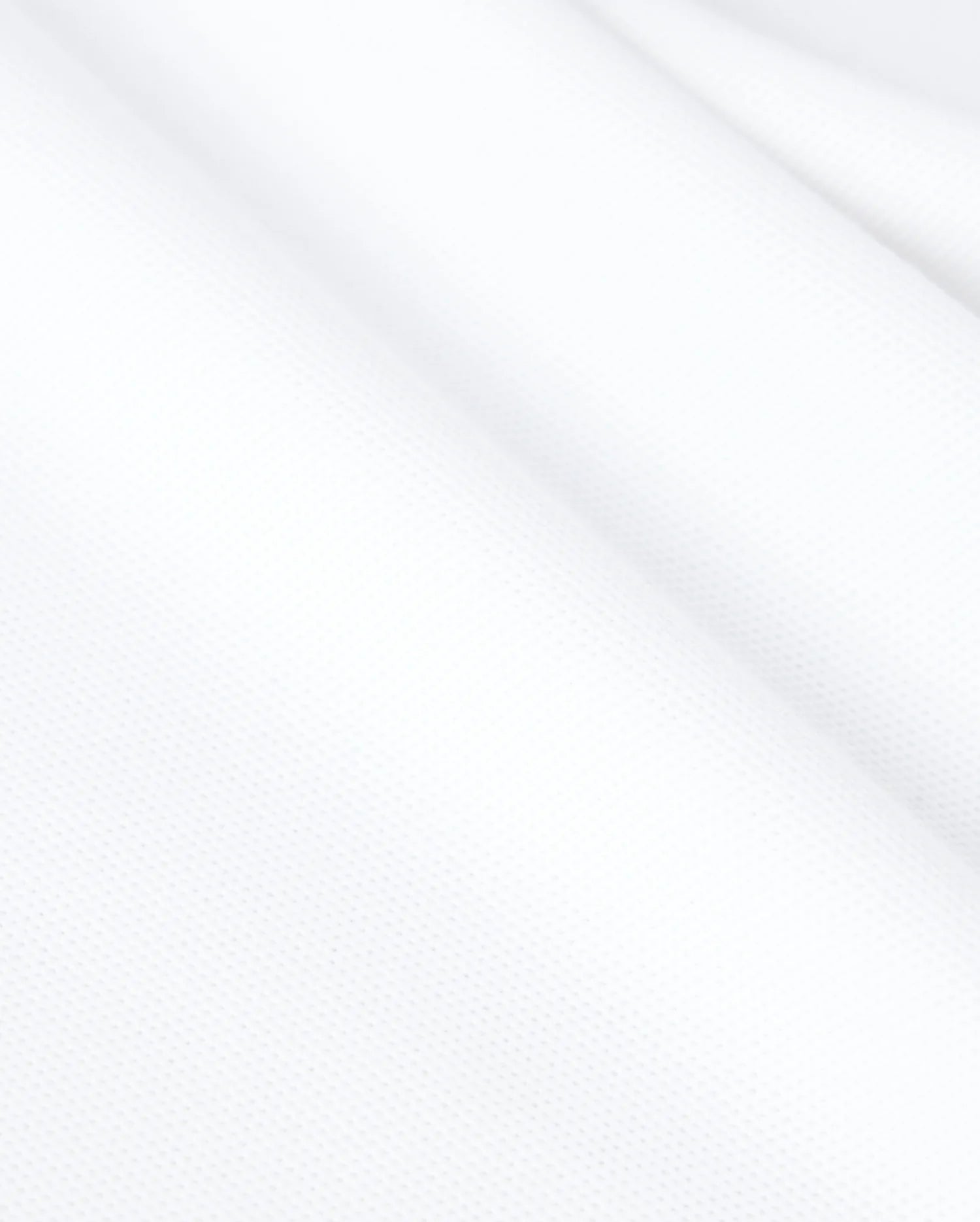 Psycho Bunny's KIDS CLASSIC PIQUE POLO SHIRT - B0K021AR00 is made from white textured Pima cotton with a slightly wavy surface, revealing a fine weave and smooth appearance ideal for a classic polo.