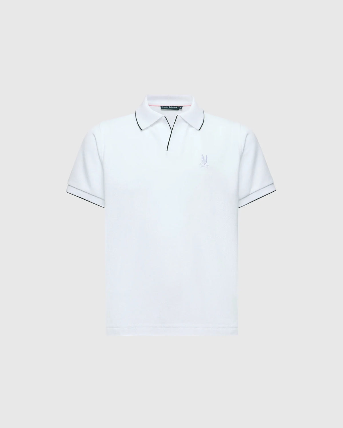 The KIDS EAST HILLS JOHNNY COLLAR POLO - B0K331B200 by Psycho Bunny is a white polo shirt with a Johnny collar and short sleeves set against a gray background. It displays black piping on the collar and sleeves, crafted from soft Pima cotton, featuring a small, subtle seaside-themed logo on the left chest.
