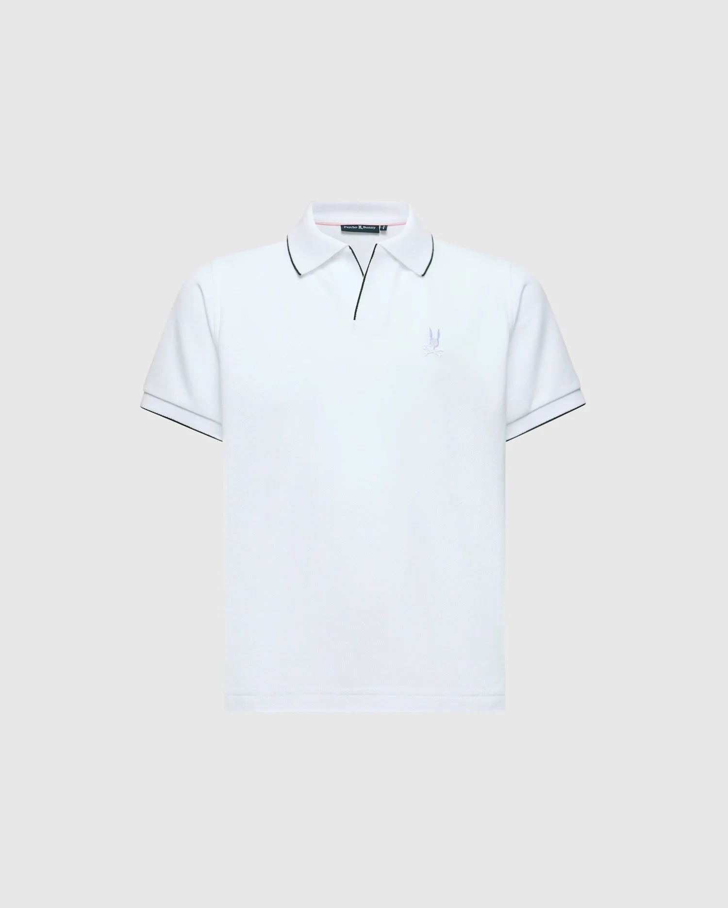 The KIDS EAST HILLS JOHNNY COLLAR POLO - B0K331B200 by Psycho Bunny is a white polo shirt with a Johnny collar and short sleeves set against a gray background. It displays black piping on the collar and sleeves, crafted from soft Pima cotton, featuring a small, subtle seaside-themed logo on the left chest.