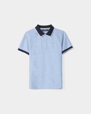 A KIDS WINDCREST PIQUE POLO SHIRT - B0K592C200 in light blue with a color blocked collar and sleeve trim. The dark blue collar features a white stripe on the edge, and the shirt has two buttons at the neckline. A raised-embroidered chest Bunny adorns the left chest area, set against a plain white background by Psycho Bunny.
