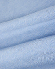Close-up of soft, folded blue fabric with a smooth and slightly textured surface. The fabric's weave is visible, highlighting its fine, uniform texture. Made from luxurious Pima cotton polo material used in the KIDS WINDCREST PIQUE POLO SHIRT - B0K592C200 by Psycho Bunny, the appearance is clean and gentle, creating a sense of comfort and coziness.