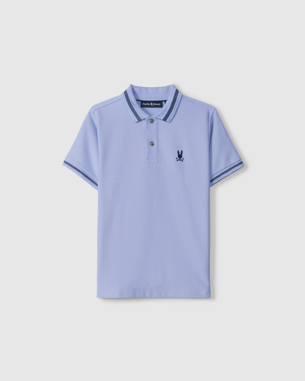 The Kids Riviera Pique Polo Shirt (B0K640C200) by Psycho Bunny is a light blue polo made from Pima cotton piqué. It features short sleeves and a collar, both trimmed with dark blue stripes, along with an embroidered dark blue Bunny logo on the left chest.