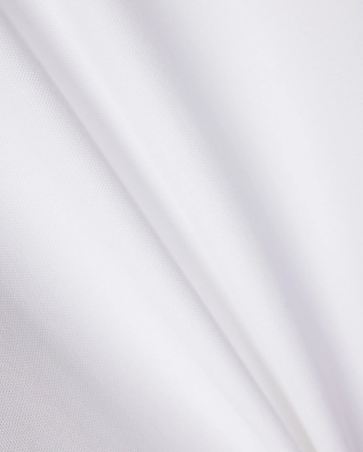 A close-up of a smooth, white Pima cotton fabric with subtle, diagonal creases. The texture appears soft and light, showcasing the clean and pristine appearance of the KIDS RIVIERA PIQUE POLO SHIRT - B0K640C200 by Psycho Bunny, reminiscent of a refined Riviera polo.