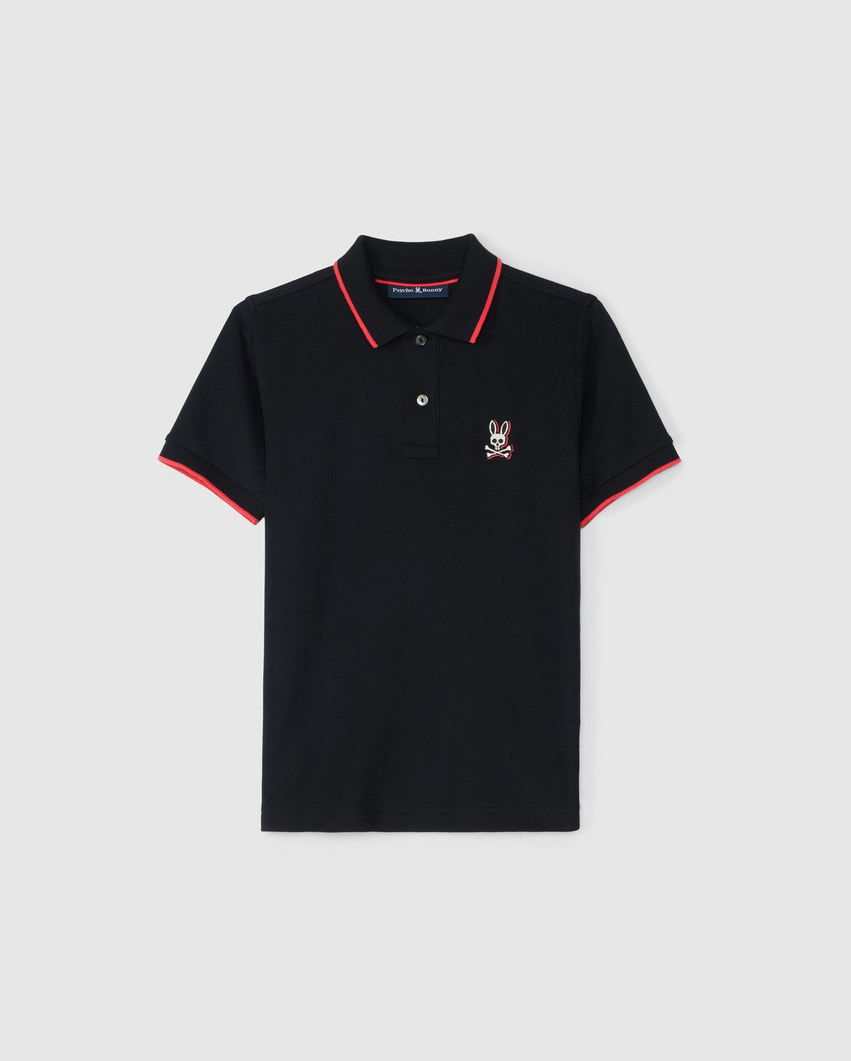 The KIDS KAYDEN PIQUE POLO - B0K675C200 by Psycho Bunny is a black polo shirt accented with red trim on the collar and sleeve cuffs. It has a small, white, embroidered rabbit logo on the left chest. Crafted from Pima cotton piqué, this shirt features a two-button placket and is showcased against a plain white background.