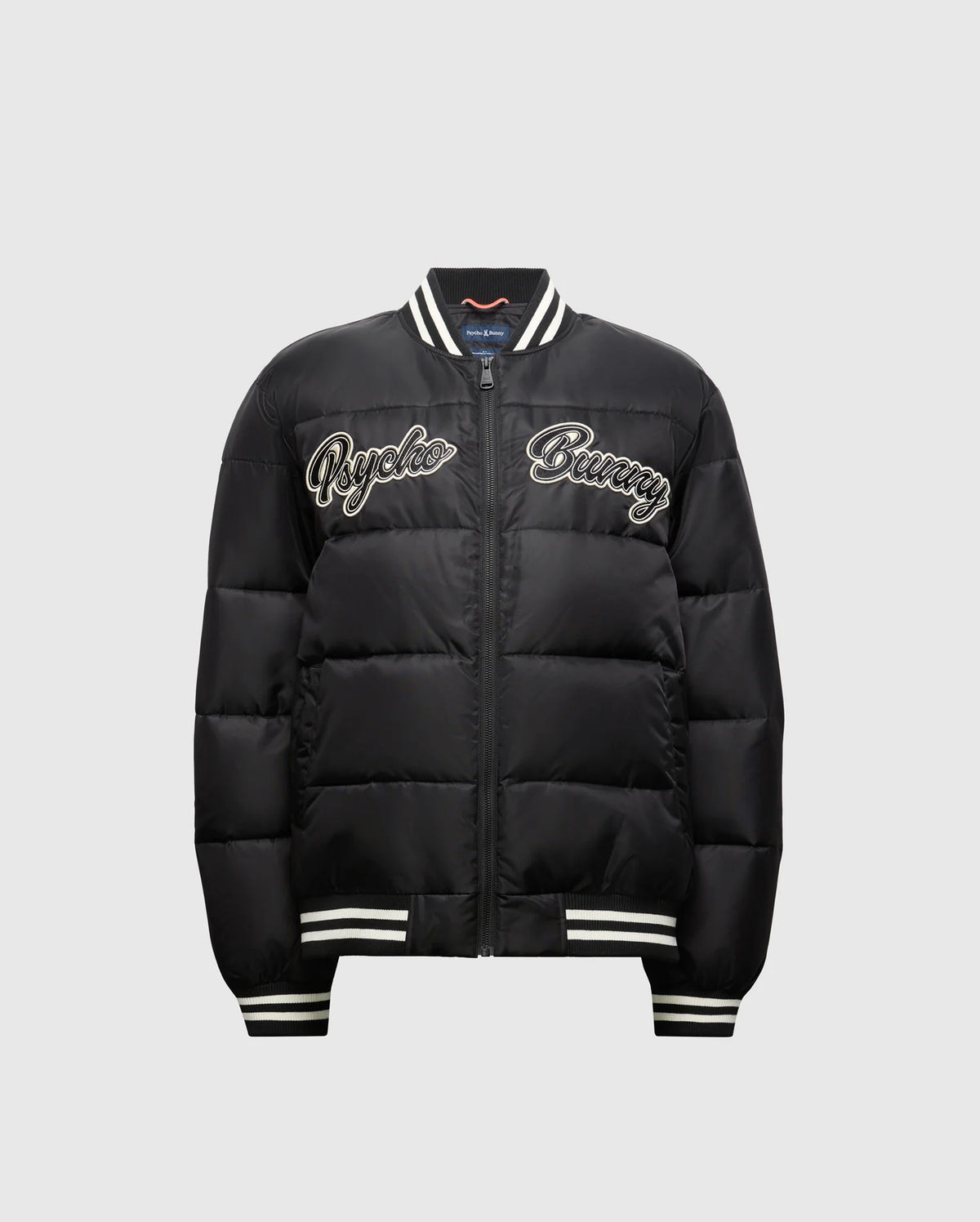 Check out the KIDS FRASER FASHION PUFFER (B0N338E200) from Psycho Bunny for your child. This trendy black jacket showcases white "Psycho Bunny" lettering on the front and includes a zip closure, along with striped ribbed cuffs and collar, making it an ideal choice for keeping your child stylish and warm.