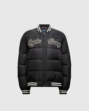 Check out the KIDS FRASER FASHION PUFFER (B0N338E200) from Psycho Bunny for your child. This trendy black jacket showcases white "Psycho Bunny" lettering on the front and includes a zip closure, along with striped ribbed cuffs and collar, making it an ideal choice for keeping your child stylish and warm.