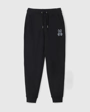 The KIDS LENOX REGULAR FIT SWEATPANT by Psycho Bunny is a pair of black jogger pants with an elastic waistband, drawstring, and ribbed ankle cuffs. These kids' sweatpants also feature a white embroidered graphic of a rabbit head above crossed bones on the left pocket.