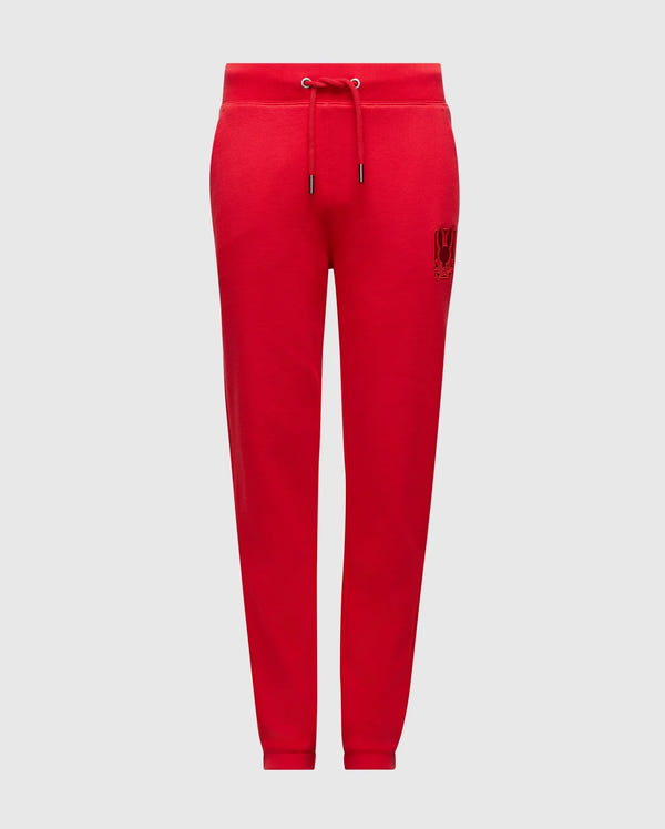 The Psycho Bunny Kids Pierce Essential French Terry Sweatpants, product code B0P136E200, come in a vibrant red and feature an adjustable drawstring waistband with a small embroidered design on one leg. Made from premium quality fabric, these joggers are shown against a white background, ensuring style and comfort for your little ones.