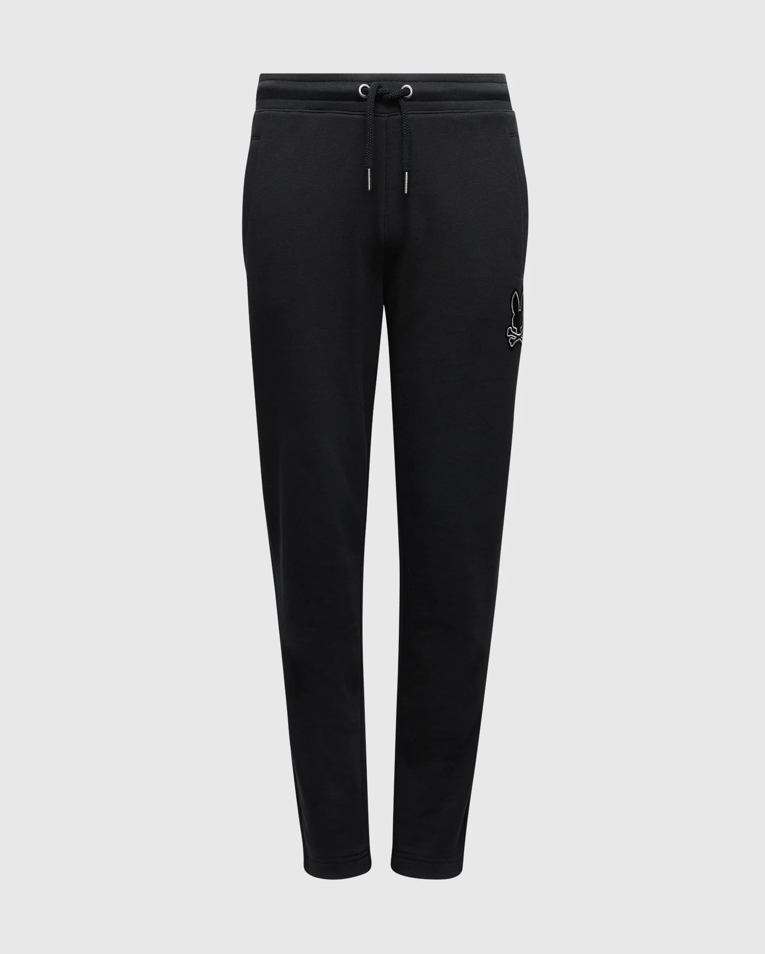 Introducing the Psycho Bunny KIDS ALEXANDER SWEATPANT - B0P155E200, crafted from a black cotton blend material. These joggers feature an elastic waistband with a drawstring for added comfort, and display a subtle white embroidered logo on the left thigh. Equipped with front pockets, these cozy sweatpants are presented against a plain white background.