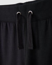 Close-up of the KIDS WALTER LIGHTWEIGHT SWEATPANT - B0P860D200 by Psycho Bunny. The image highlights the waistband and two black drawstrings with silver eyelets. The fabric appears soft and comfortable, showcasing the casual wear design and ensuring a breathable fit for all-day comfort.