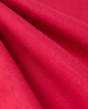 Close-up of the red fabric in the KIDS WALTER LIGHTWEIGHT SWEATPANT - B0P860D200 by Psycho Bunny. The texture appears soft and smooth, with even, consistent coloration. The fabric catches light subtly, highlighting its fine weave and slight sheen—perfect for a breathable fit in casual wear or lightweight sweatpants.