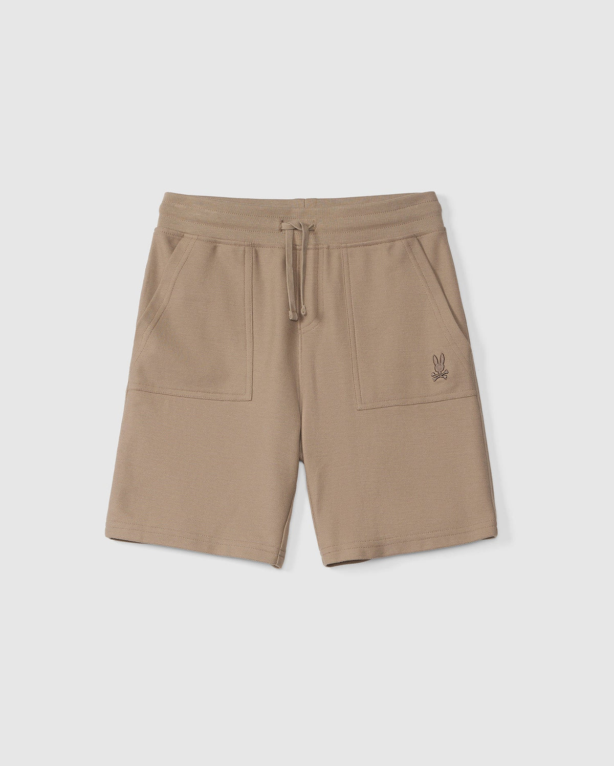 The KIDS STANFORD LIGHT PIQUE SWEATSHORT - B0R344B200 by Psycho Bunny are tan-colored, elastic-waist sweatshorts with a drawstring. Made from lightweight Pima cotton, these stylish wardrobe staples feature two front pockets and an embroidered logo of a small rabbit on the left pocket.