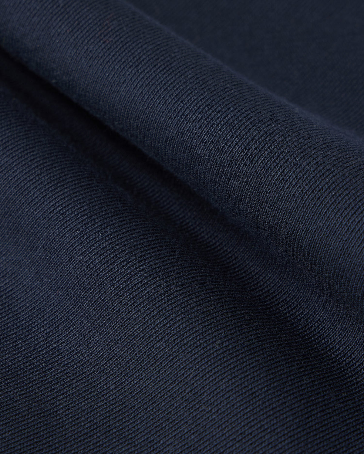 The Psycho Bunny Kids Lenox Sweatshort (B0R377B200) features dark blue, naturally breathable fleece with a ribbed texture. The folded fabric reveals a soft, smooth surface—ideal for an active lifestyle.