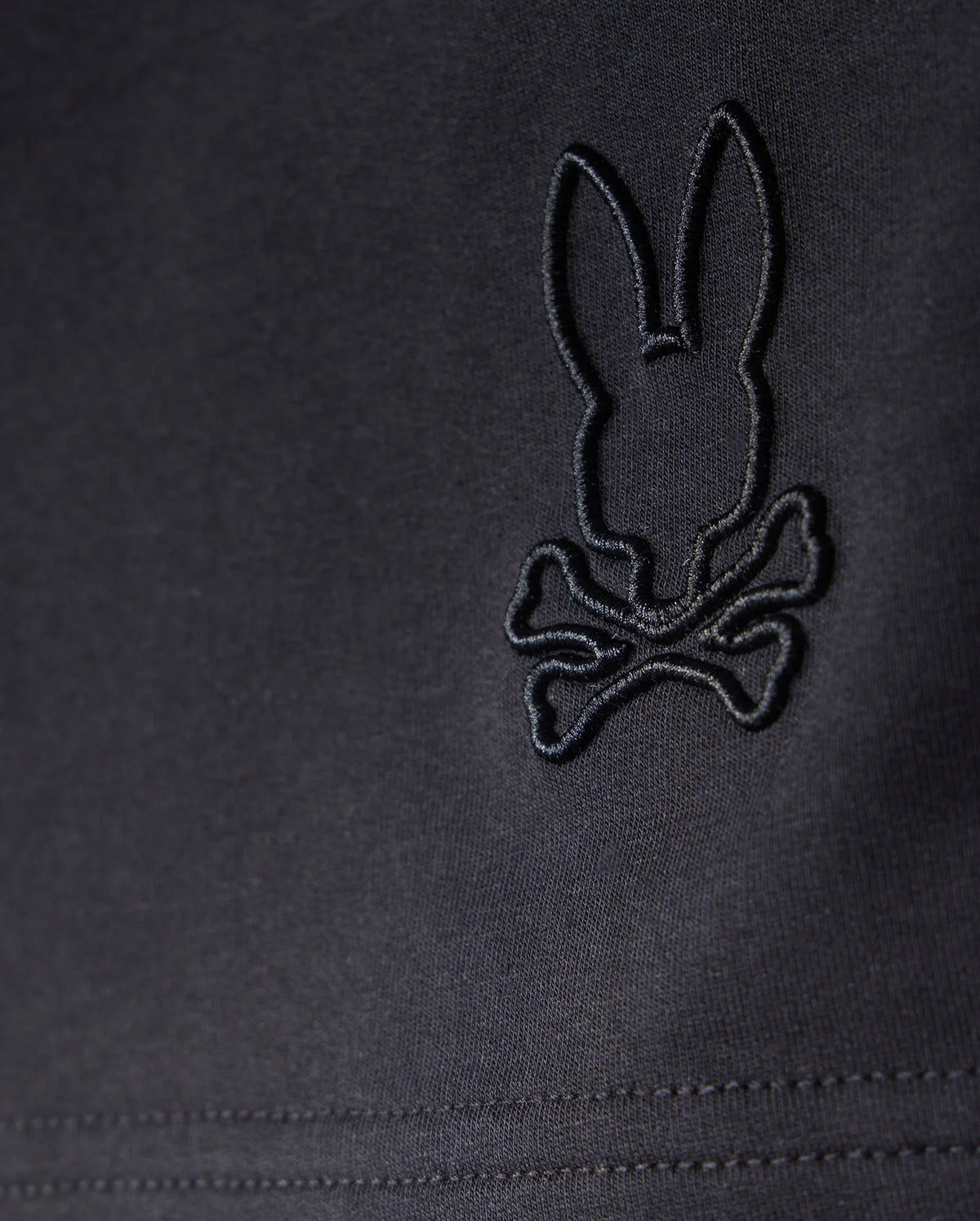 A black Micro French Terry fabric featuring a rabbit and crossbones design, perfect for KIDS LIVINGSTON TERRY SWEATSHORT - B0R408B200 by Psycho Bunny that combines comfort and style.