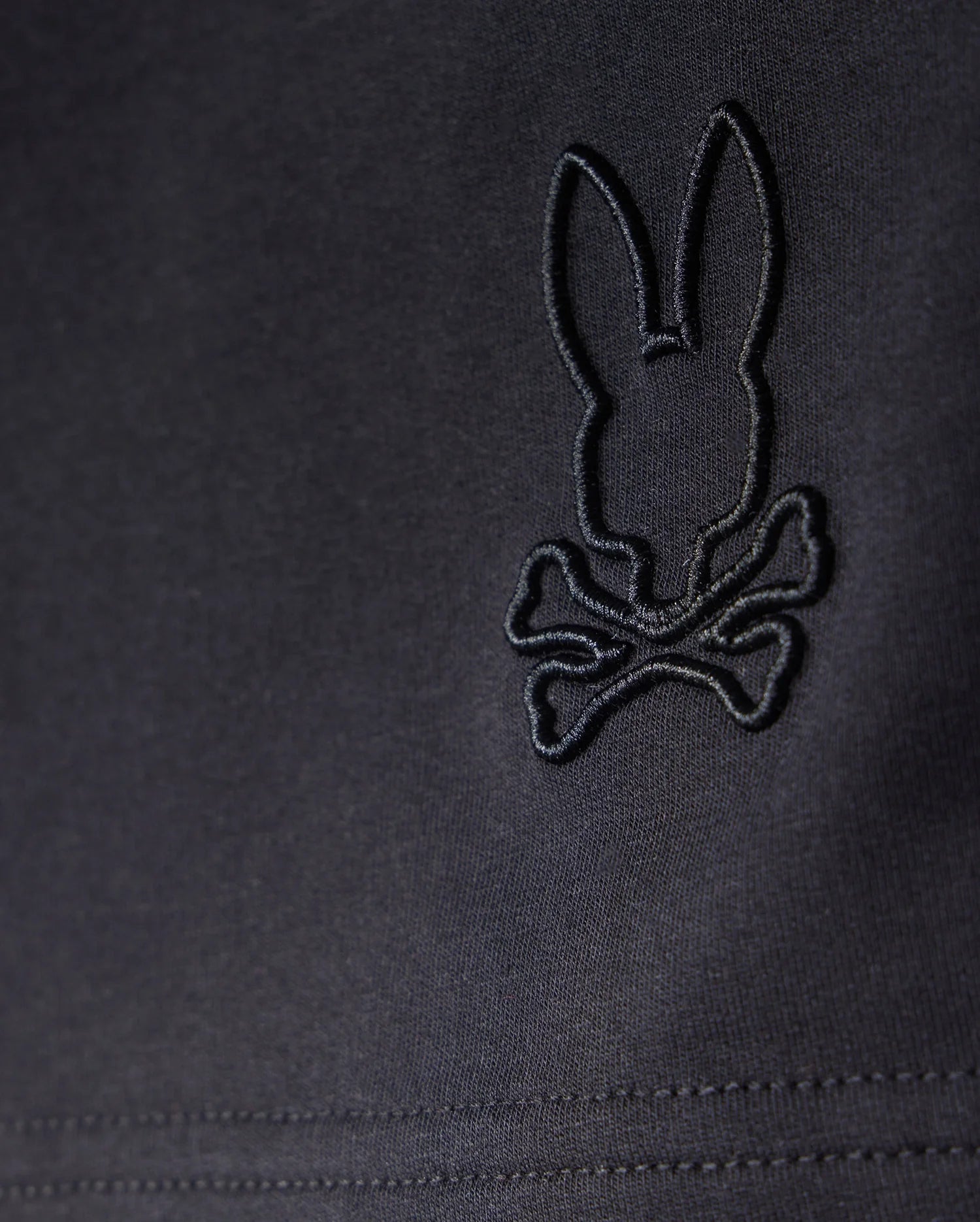 A black Micro French Terry fabric featuring a rabbit and crossbones design, perfect for KIDS LIVINGSTON TERRY SWEATSHORT - B0R408B200 by Psycho Bunny that combines comfort and style.