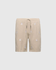 Psycho Bunny's KIDS ALL OVER WILLIS STRETCH TENCEL SHORT in beige features an elastic waist and embroidered bunny patterns across light gray fabric. (Product Code: B0R559F200).