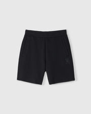 Psycho Bunny Kids Lyons sweatshorts in plain black with an elastic waistband and drawstrings, featuring two side pockets and a small embroidered rabbit design near the bottom left hem on a white background.