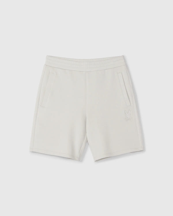 A pair of light gray, knee-length kids casual shorts with an elastic waistband and two side pockets. Made from a soft stretch modal-cotton-blend jersey, these Psycho Bunny KIDS LYONS SWEATSHORT - B0R578C200 feature a subtle embroidered design near the bottom of the left leg depicting a small bunny outline. Displayed against a plain white background.