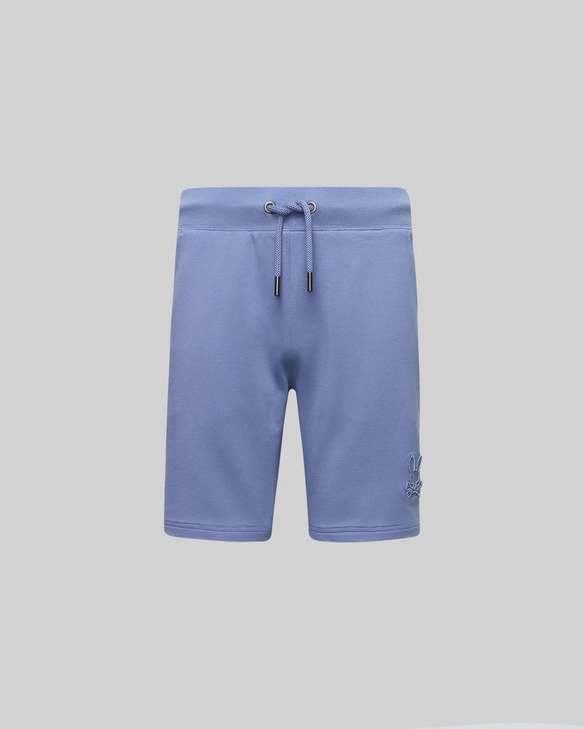 The KIDS LEVANZO FRENCH TERRY SWEATSHORT by Psycho Bunny features light blue micro French terry, metal-tipped drawcords, an elastic waistband, and a subtle embroidered Bunny logo on the lower left leg. Displayed on a plain light gray background.