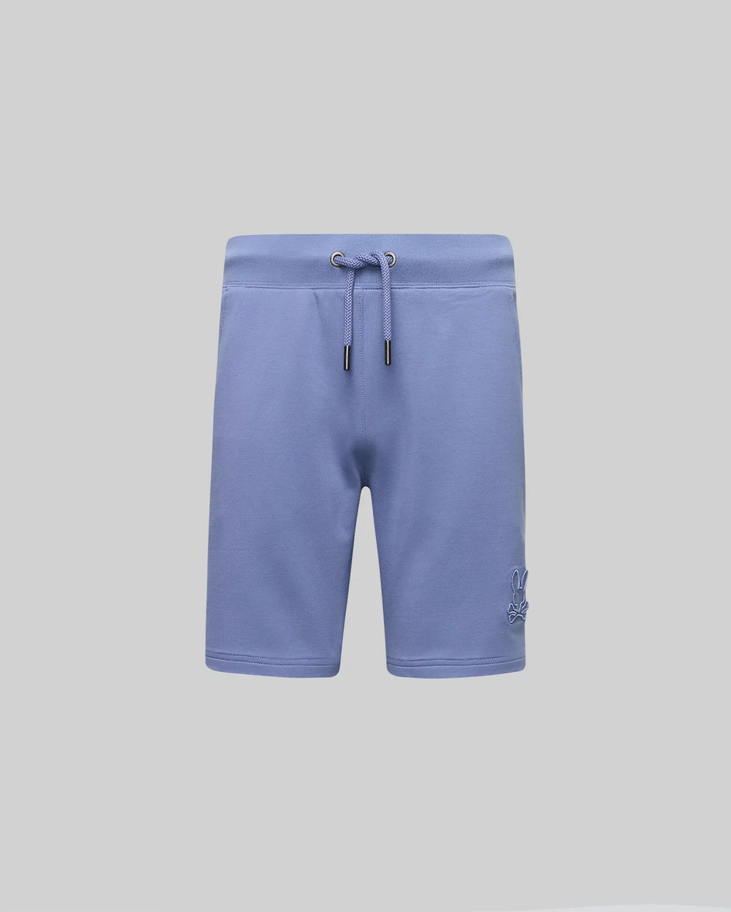 The KIDS LEVANZO FRENCH TERRY SWEATSHORT by Psycho Bunny features light blue micro French terry, metal-tipped drawcords, an elastic waistband, and a subtle embroidered Bunny logo on the lower left leg. Displayed on a plain light gray background.